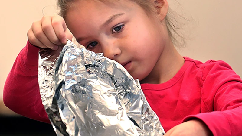 children eating aluminum foil