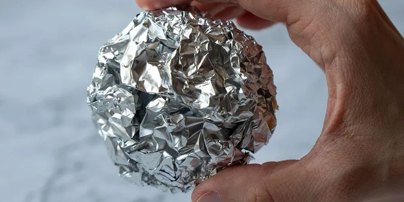 Roll the aluminum foil into a ball